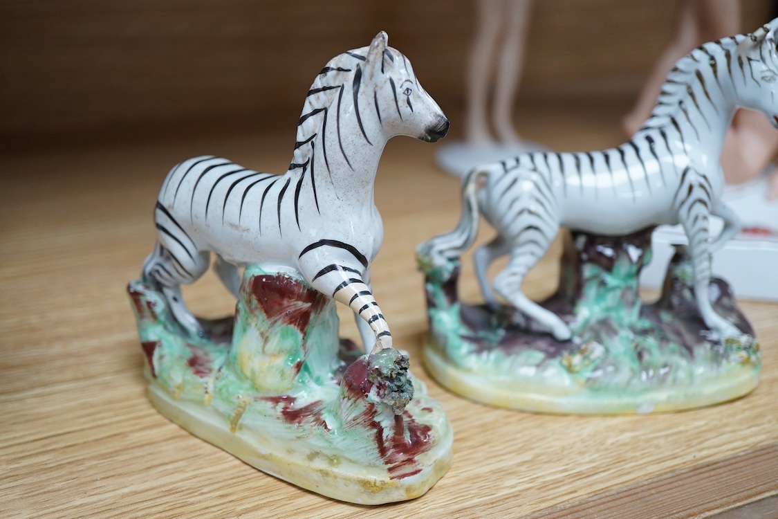 A pair of mid 19th century Staffordshire pottery models of Zebra, 12.5cm high